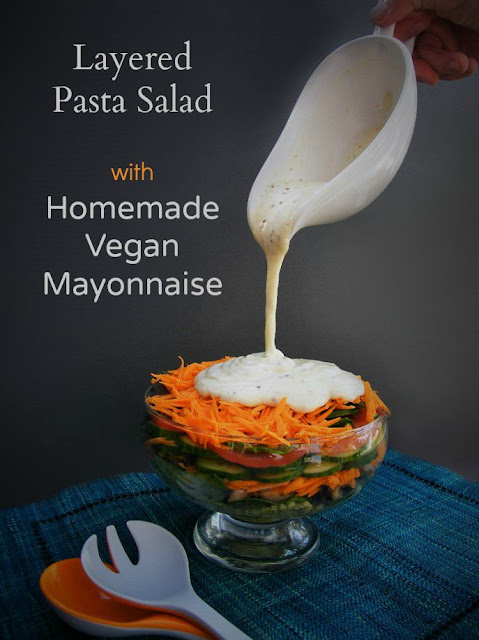 Vegan mayonnaise poured onto a Layered Salad with Pasta  Great for those on a dairy free diet - www.tinnedtomatoes.com