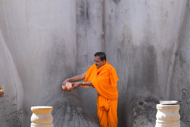 Jain priest washing the feet of Baahubali, Shravanabelagola, Karnataka
