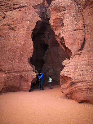 Photographers stand at the entrance to Upper Antelope Canyon in Page, Ariz.