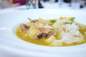 Chef Martín Omar's Sancocho served over rice with freshly sliced avocado.
