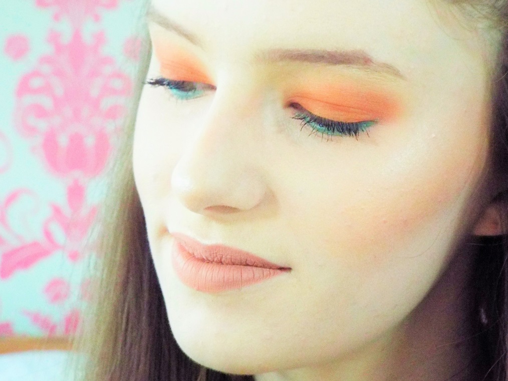 Close-up head shot showing glowing highlight on cheekbones, eye shadow blending and liquid lip up close