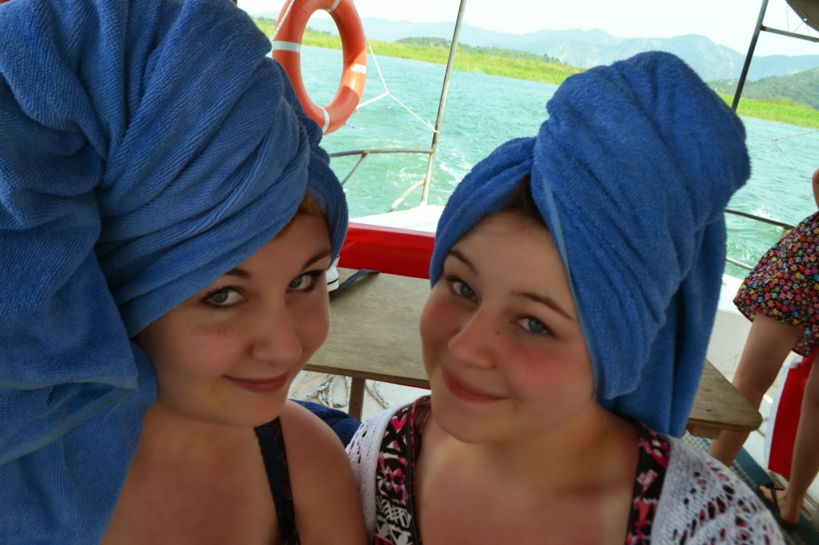 myself and my sister with beach towels on our heads as we take the boat back to Dalyan harbour