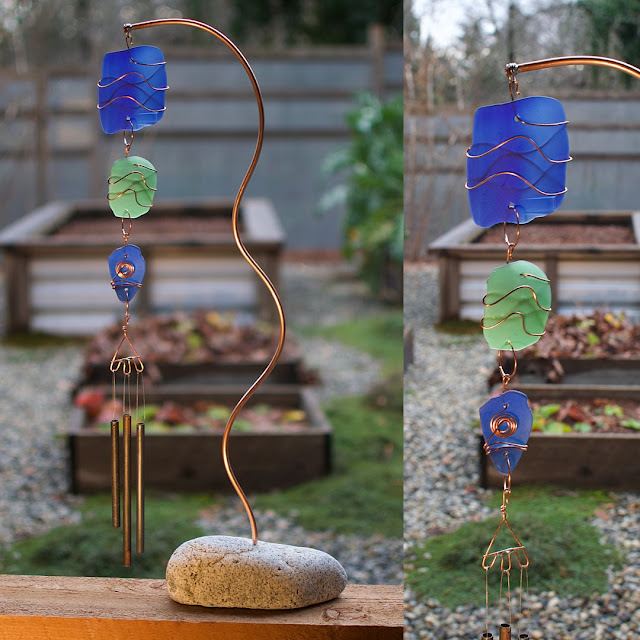 Outdoor freestanding sea glass wind chime with a beach stone base and copper support.