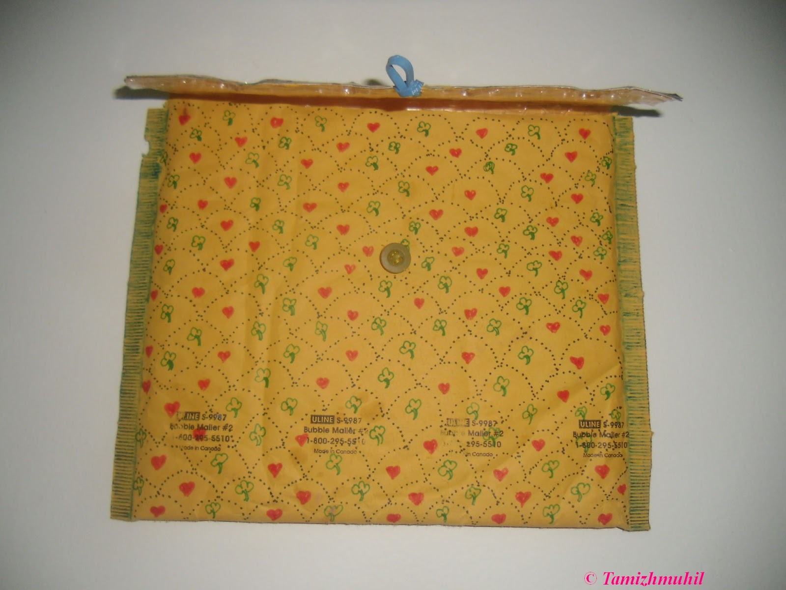 The bubble wrap envelope, the button, rubber band are the recycled items.