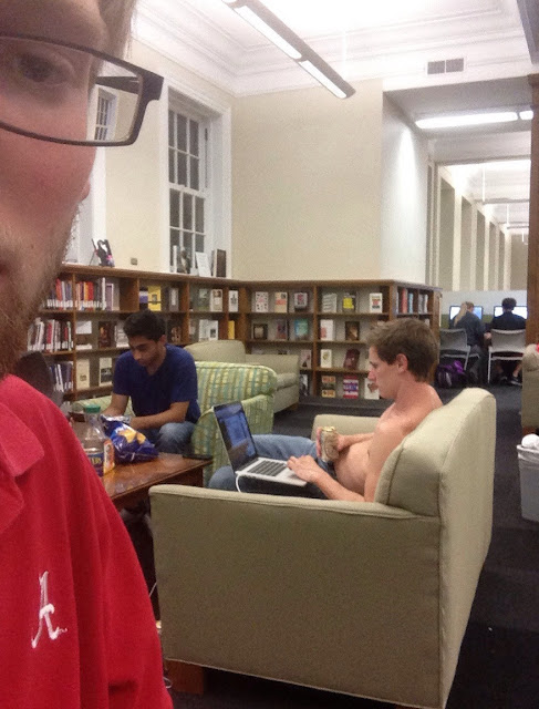 Guy with no shirt and drinking beer in the library. It must be finals. Pushup Bras and Academics. marchmatron.com