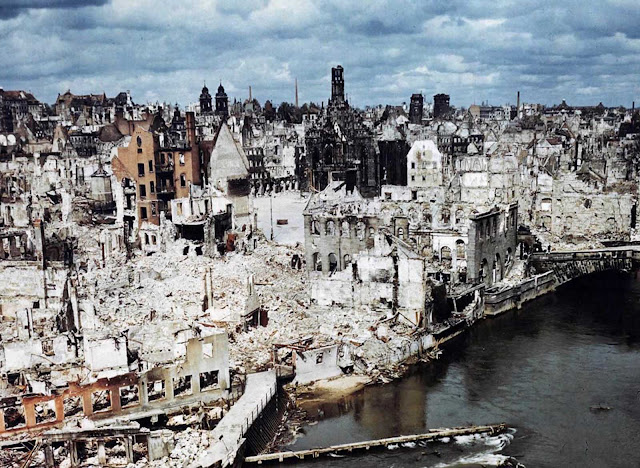 A color photograph of the bombed-out historic city of Nuremberg, Germany in June of 1945, after the end of World War II. Nuremberg had been the host of huge Nazi Party conventions from 1927 to 1938. The last scheduled rally in 1939 was canceled at the last minute due to a scheduling conflict: the German invasion of Poland one day prior to the rally date. The city was also the birthplace of the Nuremberg Laws, a set of draconian antisemitic laws adopted by Nazi Germany. Allied bombings from 1943 until 1945 destroyed more than 90% of the city center, and killed more than 6,000 residents. Nuremberg would soon become famous one last time as the host of the Nuremberg Trials -- a series of military tribunals set up to prosecute the surviving leaders of Nazi Germany. The war crimes these men were charged with included