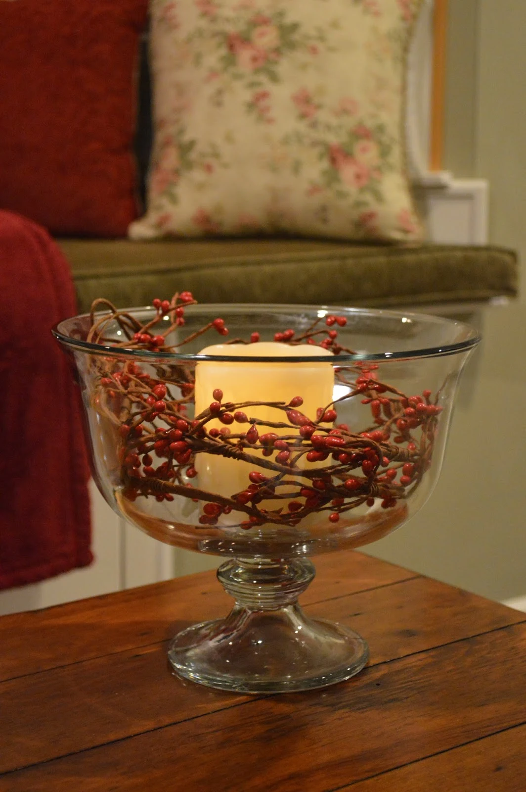 Glass bowl with candle and berries inside