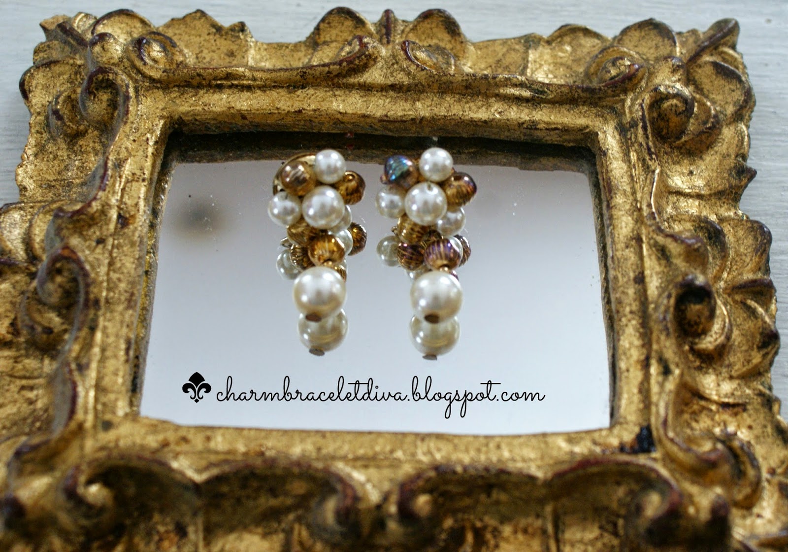 Vintage pearl and bead cluster drop earrings on mirror