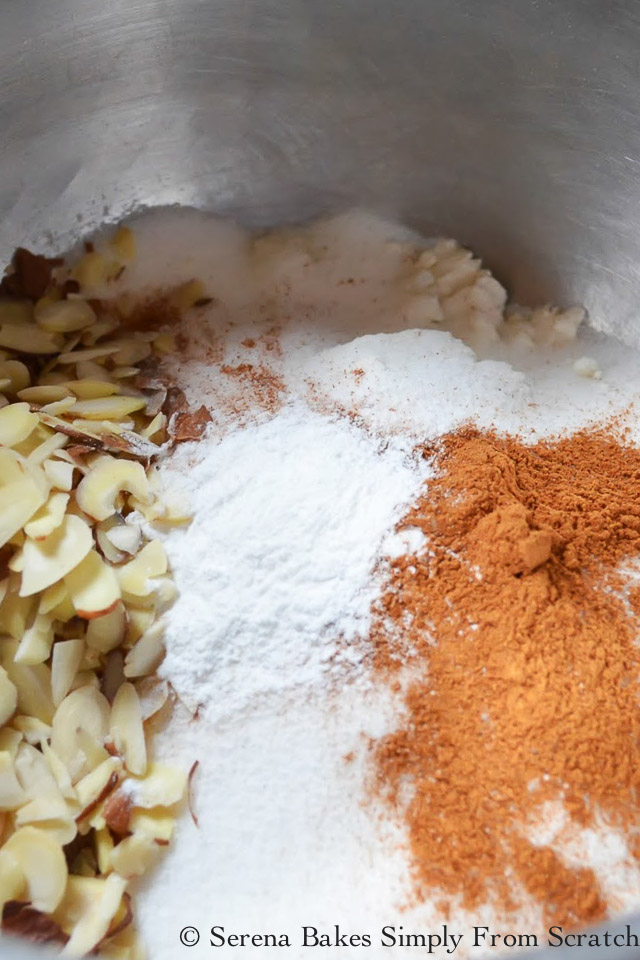 Mix together flour, sugar, baking powder, cinnamon, salt, almonds for Peach Raspberry Almond Cobbler.