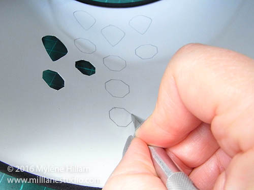 Cut out the holes for the crystals with a craft knife.