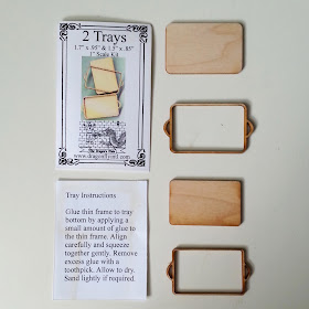 One-twelfth scale miniature tray kit pieces arranged next to the instructions.
