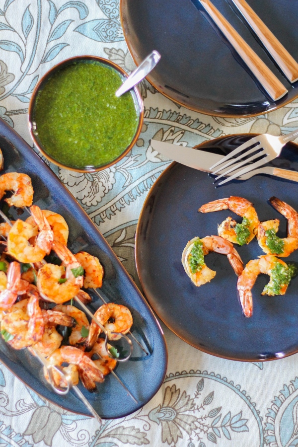 This crowd pleasing grilled shrimp recipe couldn't be easier to make! Served alongside a fresh and colorful chimichurri sauce, this is a dish you'll be making again and again!