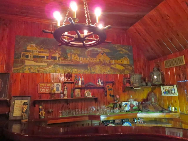 Wood-paneled bar and chandelier at the Rod and Gun Club in Everglades City Florida