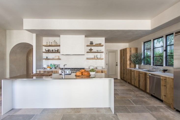 Herzig paired the plaster walls with custom cabinets and shelves made from reclaimed wood—a combination of oak, poplar, and beech–sourced from E & K Vintage Wood. She looked for especially thick planks of oak for the open shelves. The cabinets were built by Miguel Matias, who Herzig works with on all her projects, and the Antiqued Brass Hardware is from one of Herzig’s favorite LA finds, the Golden Lion. As for the plasterwork, she herself has taken classes and is learning how to apply it, but for this project she hired a specialist who worked nights, after the dust had settled.