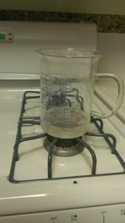 cloudy solution of lye and water in a beaker