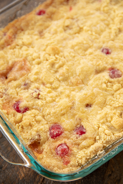 Pineapple Upside Down Dump Cake - so easy! Only 5 ingredients - pineapple, cherries, brown sugar, cake mix and butter. Simply dump everything in the cake pan and bake! No dirty dishes! Serve warm or at room temperature with ice cream. Great for a crowd! We love this at potlucks, summer cookouts, Thanksgiving, Christmas and Easter! #easy #cake #dessert #dumpcake #pineapple cake in a cake pan