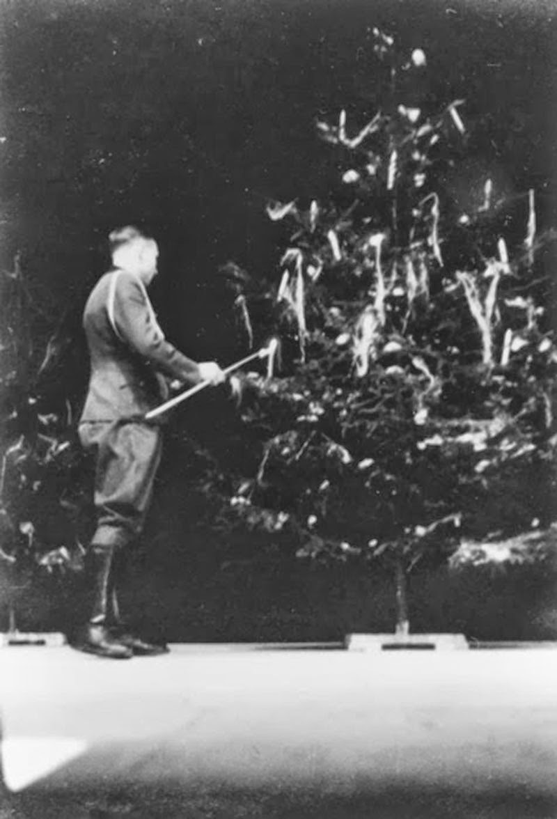 Christmas 1944: Karl Höcker lights the candles of a Christmas tree.