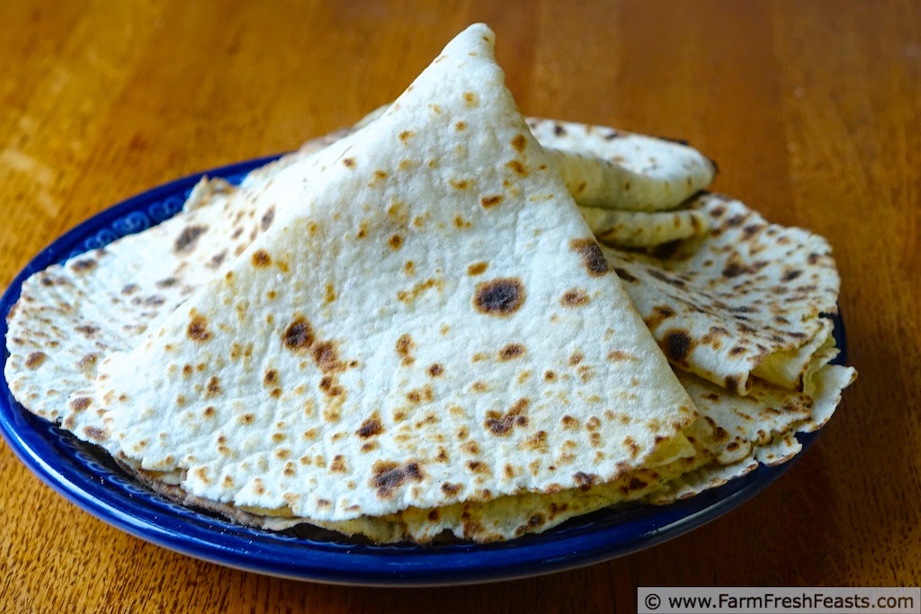 image of a blue Polish pottery plate with pieces of folded lefse piled on it