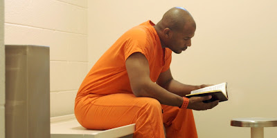 Studying-Bible-in-prison.jpg