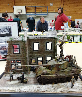 A model bombed-out building and tank diorama at a scale model exhibition.