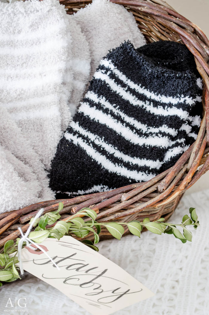 Fill a basket with heavy socks or slippers for your guests to wear while they visit your home.  ||  www.andersonandgrant.com