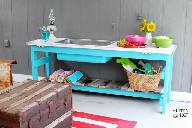 outdoor party buffet with salvaged sink and door