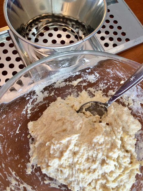 Bowl of Spatzle dough and a Spatzle maker.