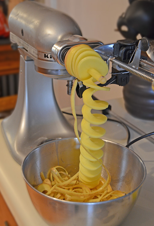 Using a Kitchenaid Spiralizer is a way to make short work out of slicing potatoes.
