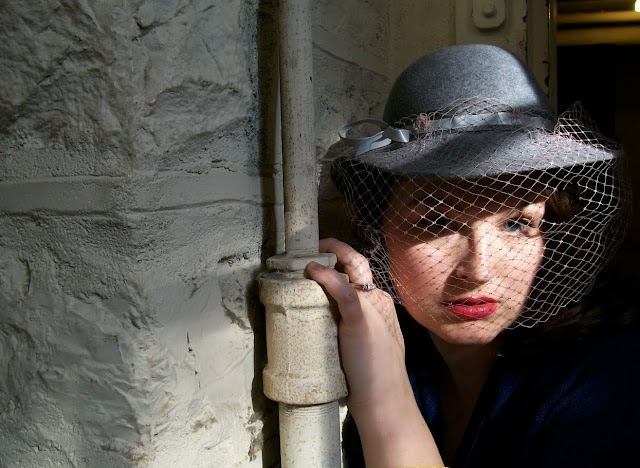 femme fatale photo in vintage veiled hat in an old asylum