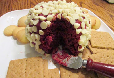 red velvet cheese ball coated in white chocolate chips with vanilla wafers and graham crackers for enjoying