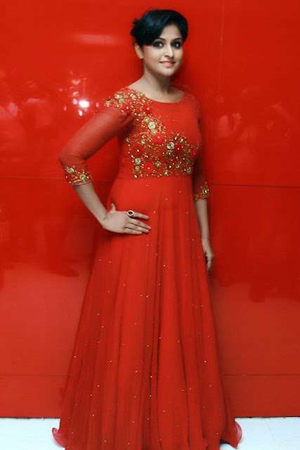 HEROINE REMYA NAMBEESAN IN LONG RED DRESS AND STANDING A RED BACKGROUND VIEW IMAGES Navel Queens HEROINE REMYA NAMBEESAN IN LONG RED DRESS AND STANDING A RED BACKGROUND VIEW IMAGES Navel Queens