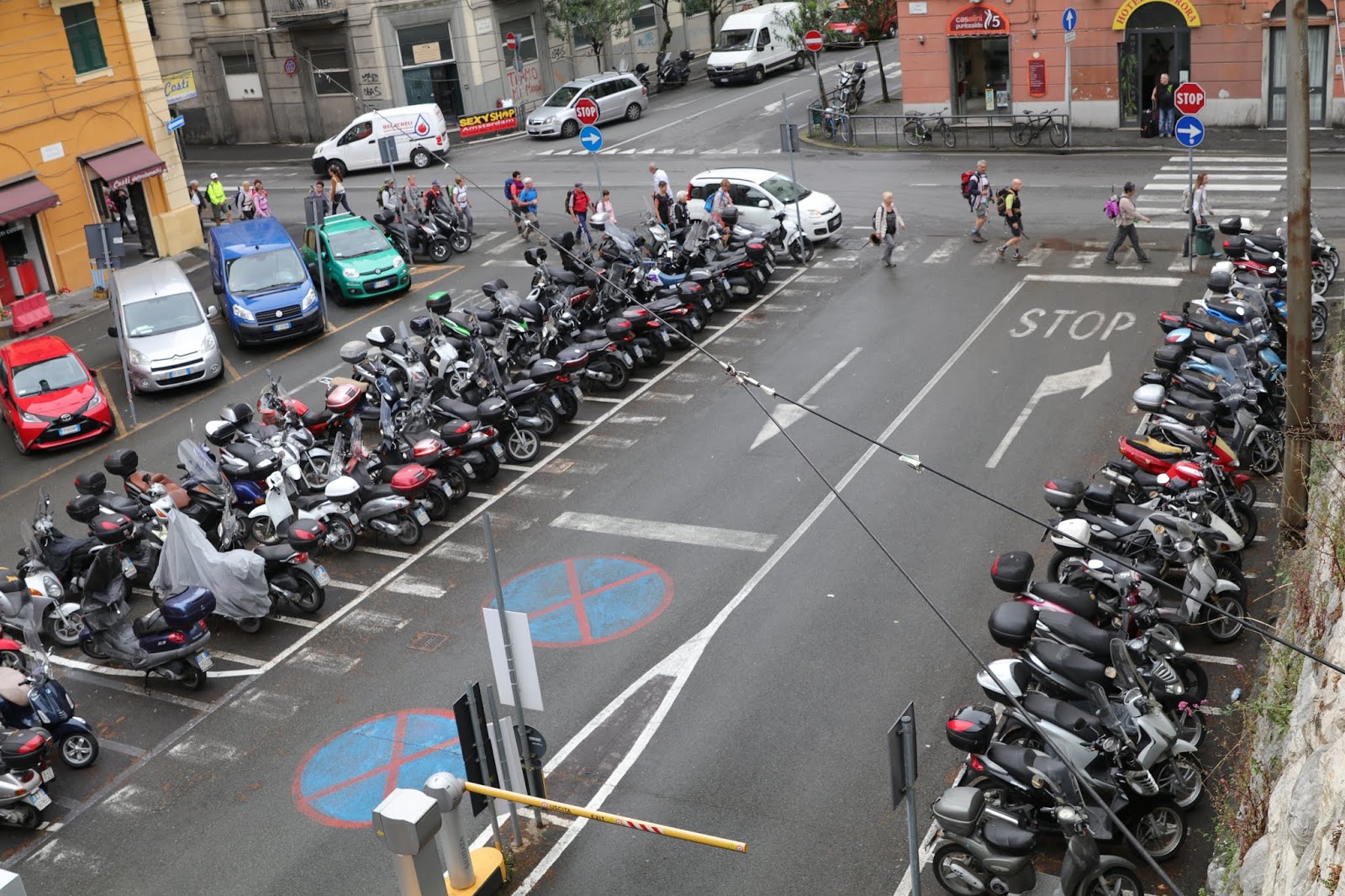 OldMotoDude Motorcycles and Scooters in a parking lot in La Spezia, Italy.