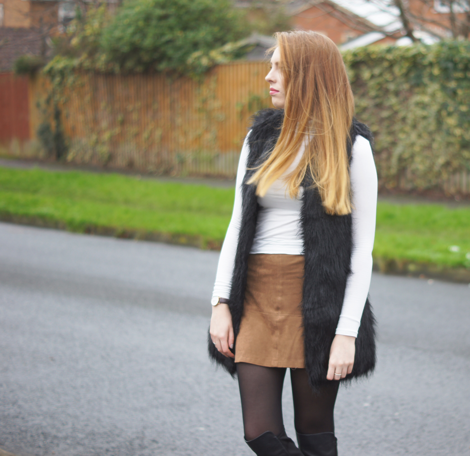 white roll neck and black fur gilet