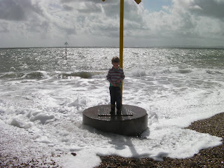 surrounded by water on a stormy beach