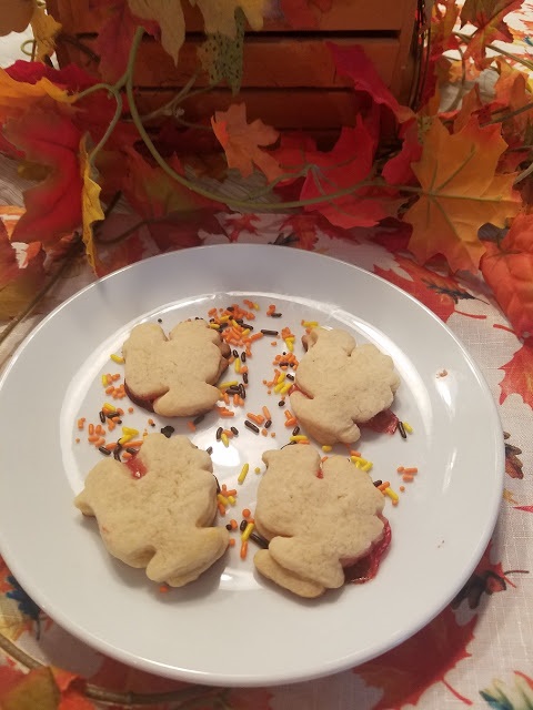 This is a shortbread cookies cut into Turkey shapes, pumpkin and leaf patterns then filled with jams and melted chocolate