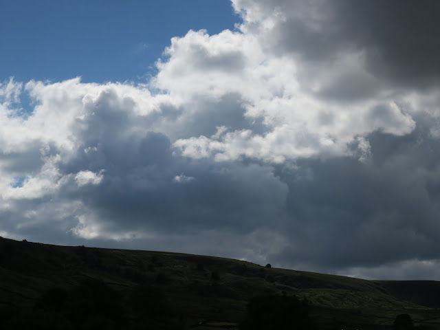Clouds dwarfing moor. Yorkshire.