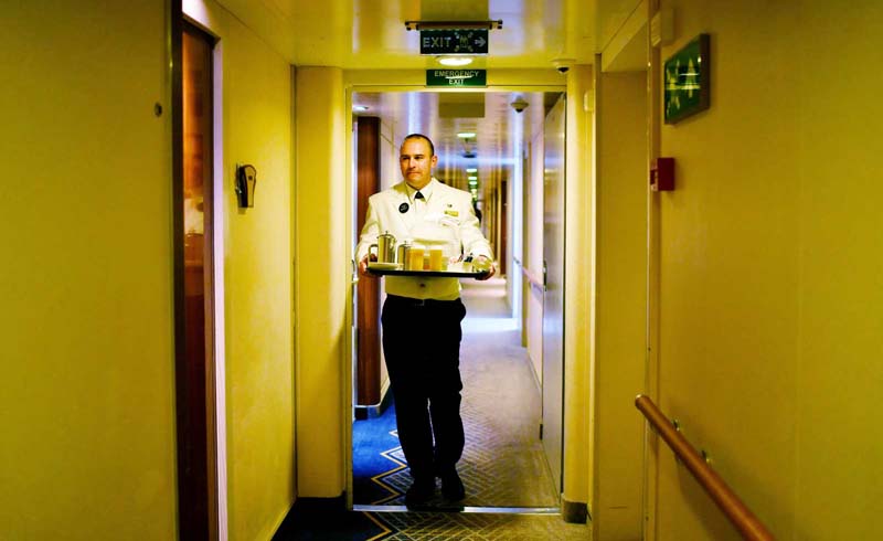 Crew member on board a Cunard cruise ship