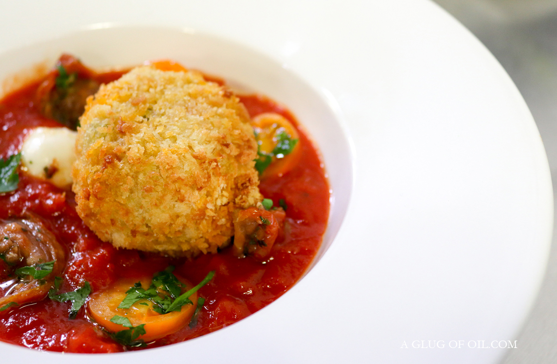 Arancini Arancini in a white bowl with pepperonata