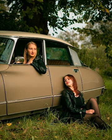 Woman Leaning On Brown Sedan Woman Leaning On Brown Sedan