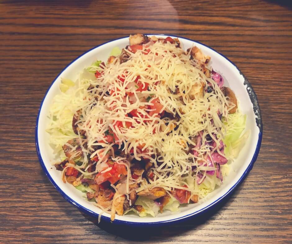 A salad bowl with lettuce, crunchy slaw, mushrooms, mild salsa, chicken and chorizo, and cheese, from Barburrito, Nottingham.