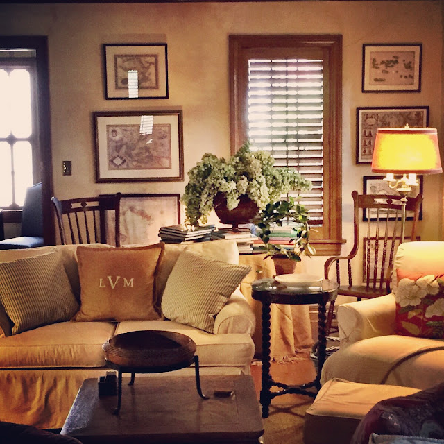 Large round book able sits behind slipcovered love seat and fireside chair. Large round book able sits behind slipcovered love seat and fireside chair.