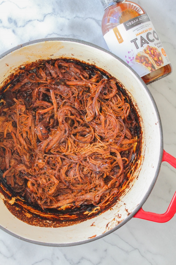 This slow cooked Jamaican Jerk Shredded Beef is cooked in a mouthwatering sweet and spicy sauce until it's tender and falling apart. Serve the shredded beef on top of tortilla chips with your favorite toppings for an epic family meal! 