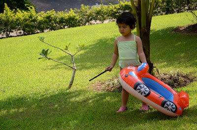Kecil and her float in the garden