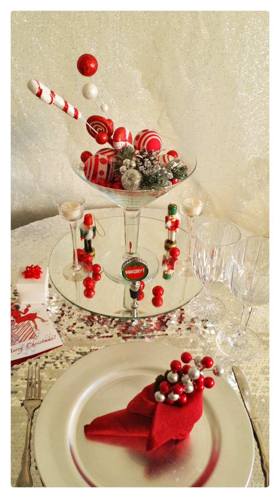 Elegant Festive Christmas Tablescape christmas table design using ornaments, sequin tablebloth, red napkins folded into elf shoe