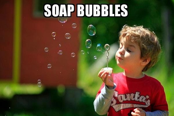 kid making soap bubbles