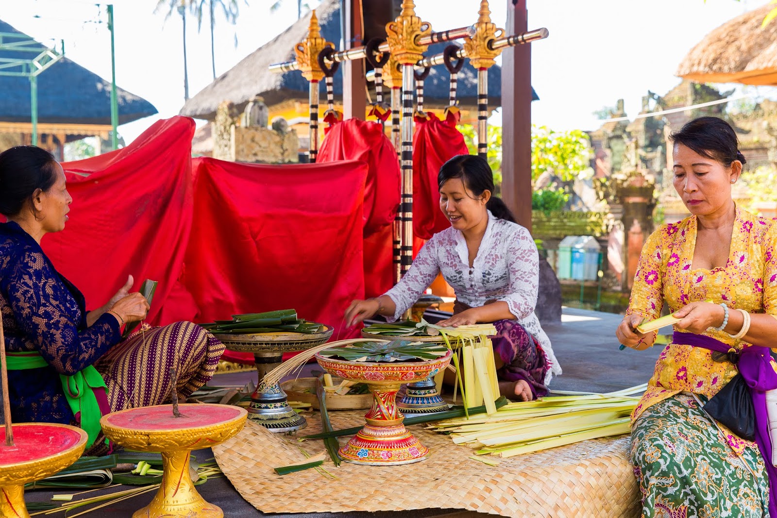 Balinese women make decorations for the temple Balinese women make decorations for the temple