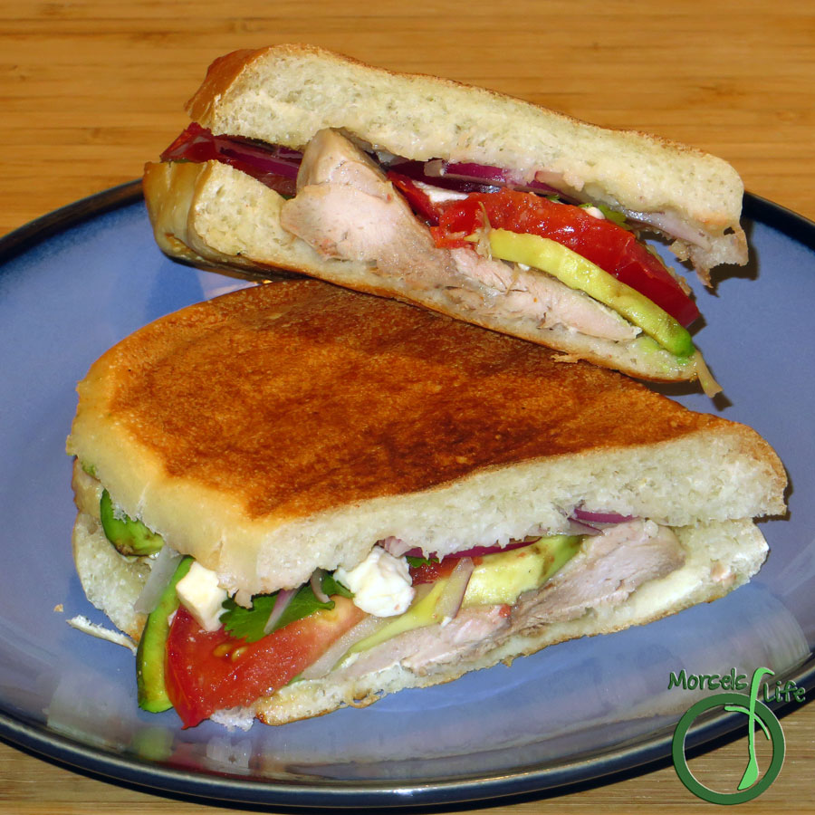 Morsels of Life - Chicken Tortas - Tender chicken, along with creamy avocado, juicy tomato, savory queso fresco, red onion, a bit of cilantro, and some sour cream lime dressing, pressed between crispy torta rolls for some delightfully scrumptious chicken tortas.