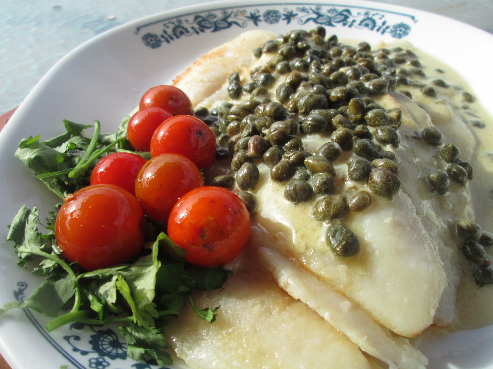 Canela kitchen (gloria) Fish with capers sauce and cherry tomatoes