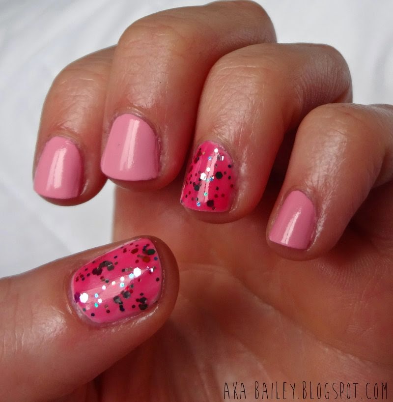 Pastel pink nails with multi-colored glitter accent nails