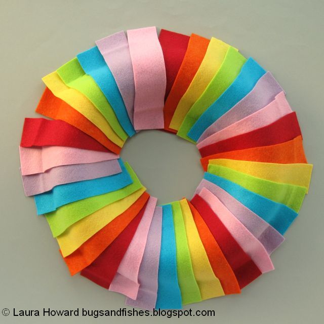 DIY January Rainbow Welcome Wreath Tutorial arranging the rainbow felt on the wreath base